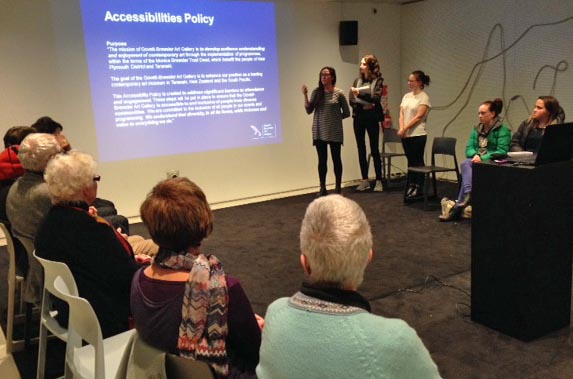 Arts For All Network members meet in Taranaki to watch a talk on developing accessibility policies.
